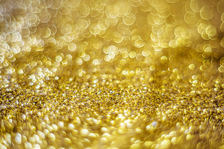 Glitter light abstract gold bokeh blurred background 