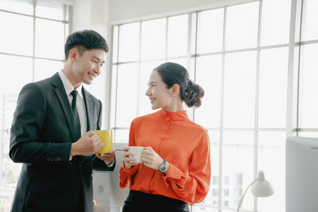 Young couple of professionals chatting during a coffee break 