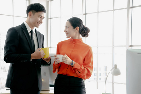 Young couple of professionals chatting during a coffee break 