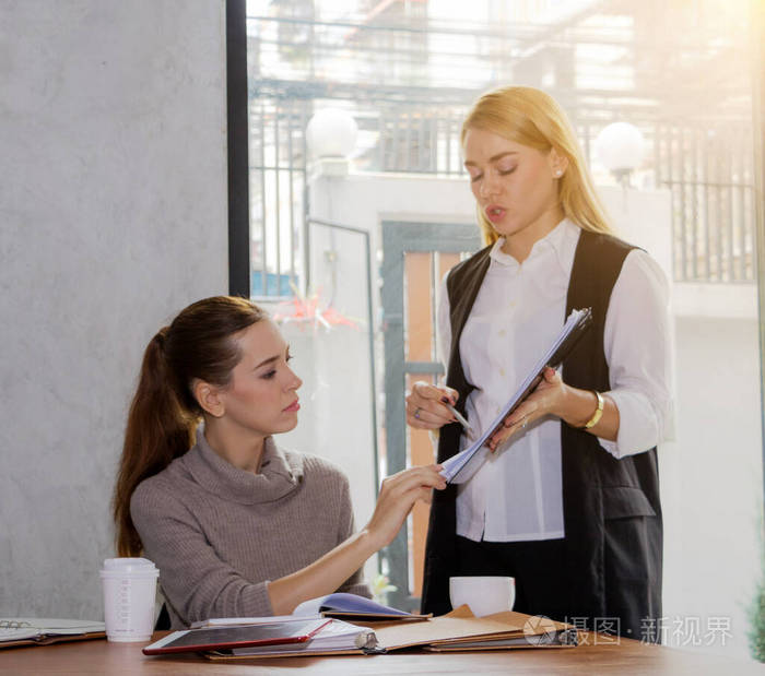 Two women are studying and teaching 