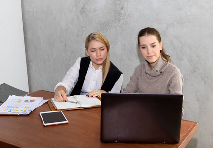 Two women are studying and teaching 