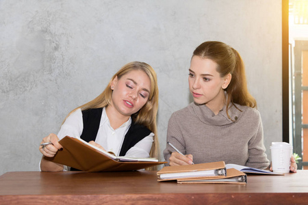 Two women are studying and teaching 