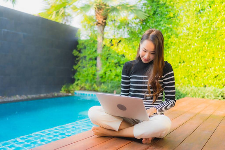 Portrait young asian woman using laptop computer around outdoor 
