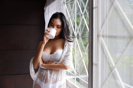 Portrait of attractive and sexy asian woman in white lingerie sl
