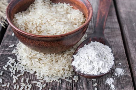 全麦粉含量至少是多少碗里放着白米,碗里放着一勺白面,背景是旧木板.