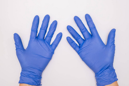 在白底病人检查时，手戴蓝色外科乳胶手套，以保护医生和护士