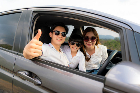 Happy Asian family with father thumb up and mother and daughter 