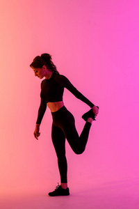 Sports girl on a bright color background does exercises. 