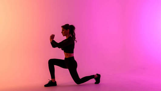 Sports girl on a bright color background does exercises. 