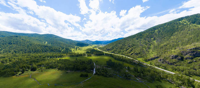 Aerial panoramic banner view of landscape with mountains, green 