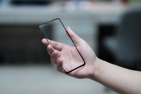 Empty glasses in human hand, future smartphone concept 