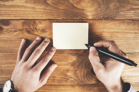 businessman showing card with pen 