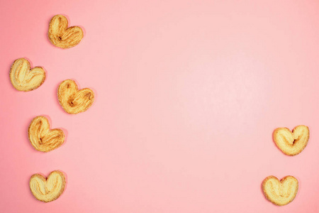 Trendy pink pastel background with heart shape cookies and copy 