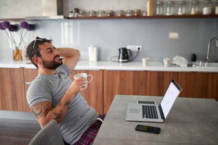 adult young male with beard and glasses on his head, relaxing   