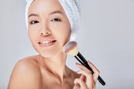 近距离看，一个皮肤完美的年轻美丽的亚洲女人在化妆。