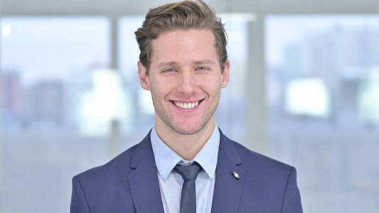 Portrait of Smiling Young Businessman Looking at Camera 