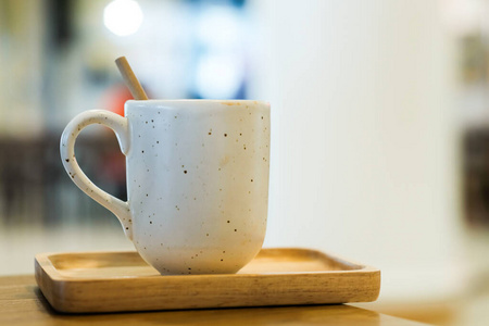 White ceramic coffee mug in cafe 