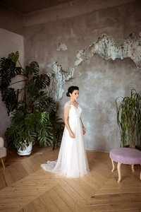 Sad bride in an elegant dress without a groom on the background 