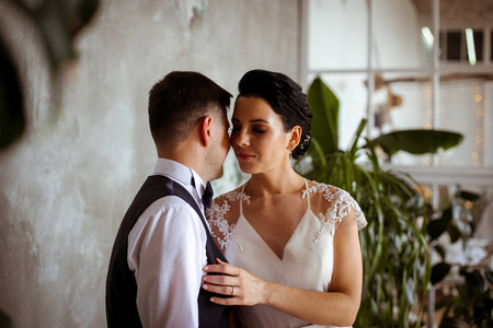 Beautiful bride in an elegant dress the groom in a waistcoat in 