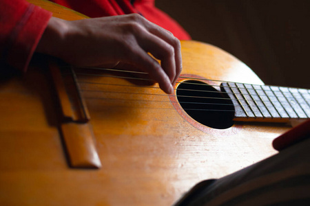 the guy plays the guitar, yellow wooden musical instrument. man 