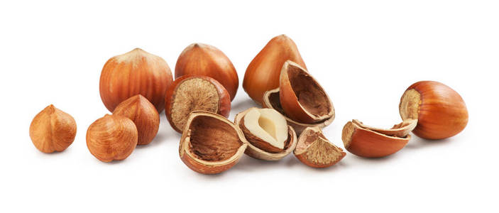 Hazelnuts on a white background. Broken hazelnuts 