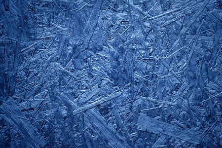 深色木质材料.面向osb的刨花板纹理.空白背景板经典蓝色与渐晕.照片