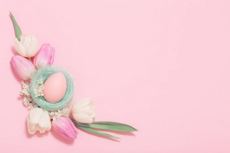 Easter eggs and spring flowers on pink background 