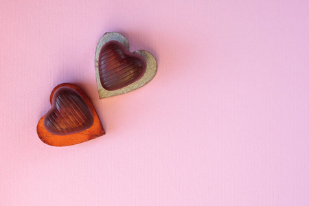 Wooden hearts and heartshaped chocolates. Greeting card for Val
