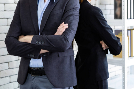 businessman and businesswoman with arms folded at In the  