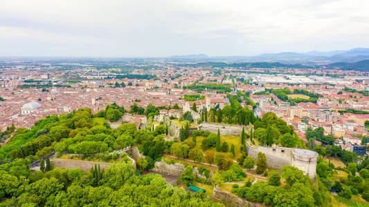 Brescia, Italy. Castello di Brescia. Flight over the city in clo