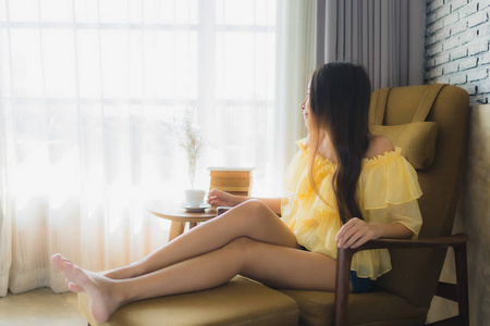 Portrait young asian woman sit on sofa chair and read book with 