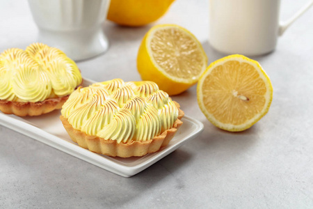 Tartlets with lemon cream on a white table. 