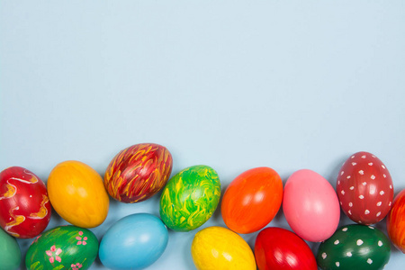 Easter background with handmade colored eggs on wooden a bright 