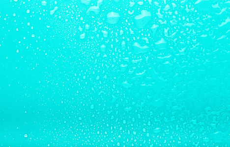 彩色背景上的水滴。选择性聚焦。蓝色