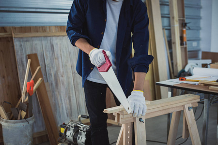 Asian man Carpenter working with technical drawing or blueprint 