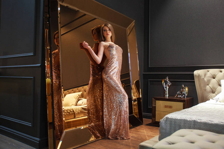 Glamorous interior golden mirror. Fashion Beautiful young woman 