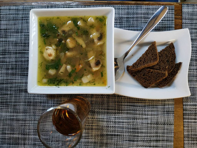 Mushroom soup with bacon. Served on a curly porcelain tray in a 