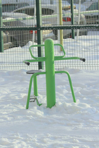 Outdoor fitness equipment on winter urban background. 