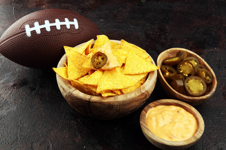 Homemade Nachos with Cheddar Cheese and Jalapenos for football. 