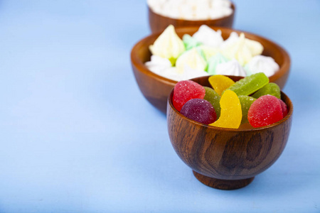 Meringue,marmalade and marshmallow in wooden bowls 