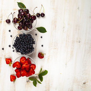  Ripe berries in transparent bowls 