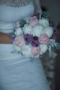 bride in a wedding dress holding a bouquet 