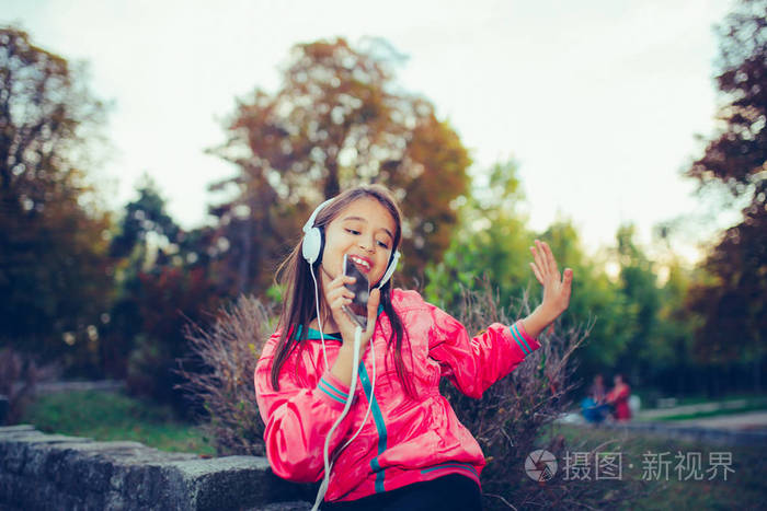 兴奋的小女孩和他一起跳舞唱歌听音乐