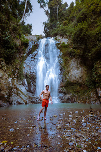 A tourist is enjoying the beauty of the waterfall in Chumphon pr