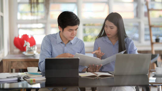 Cropped shot of businesspeople consulting on their work with tab