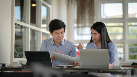 Close up view of businesspeople discussing on their work with ta