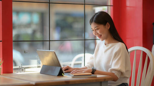 Portrait of adorable college girl working on her assignment with