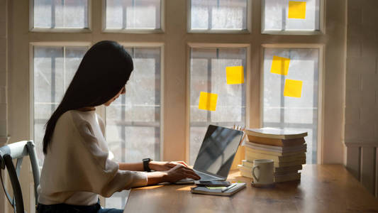 College girl working on her assignment with laptop computer in c