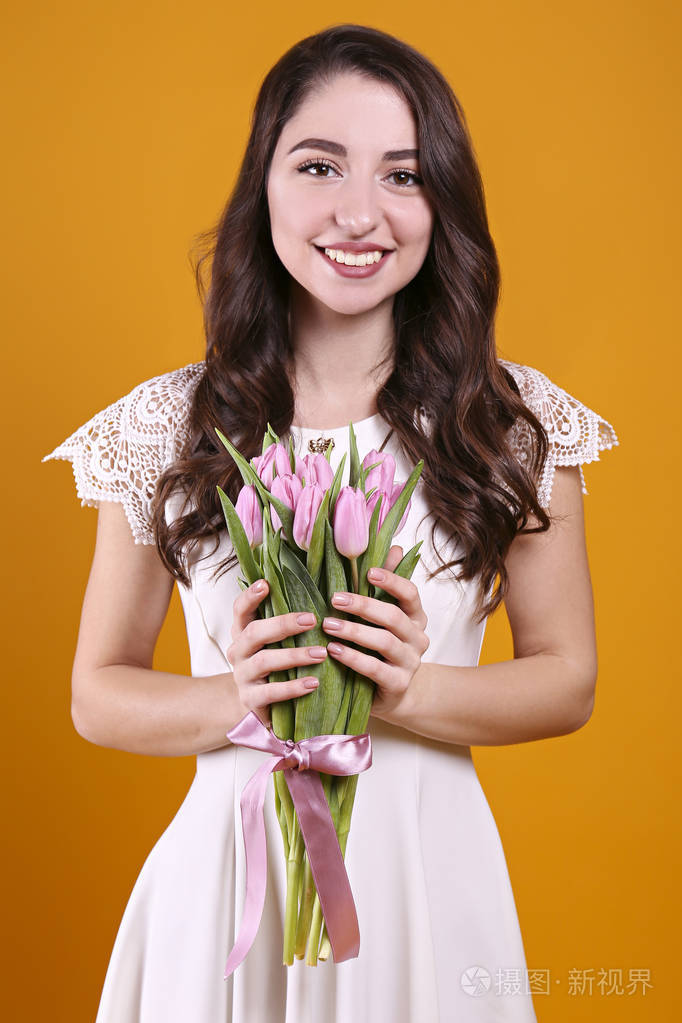 美丽的女性手持一束春天的鲜花庆祝国际妇女节