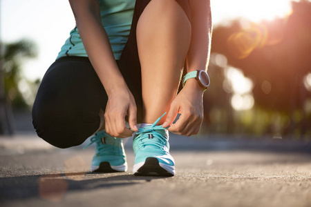 Running shoes  closeup of woman tying shoe laces. Female sport 